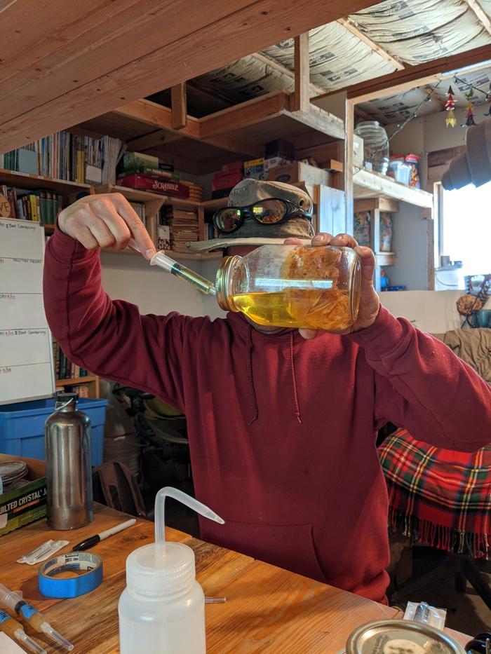 Master Fred drawing mycelium culture into a syringe for future culture inoculation