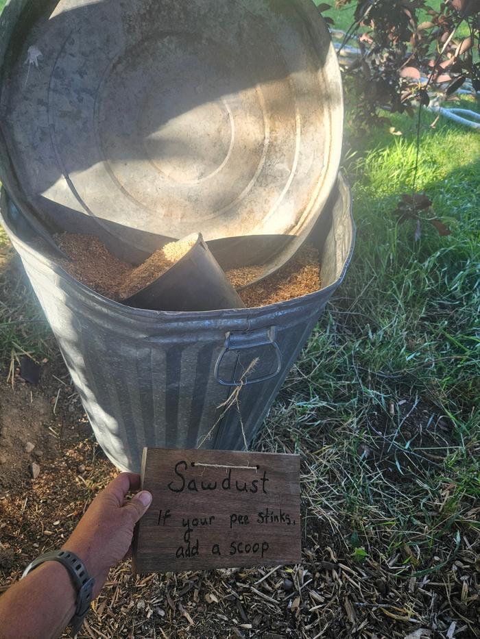 Here is the bucket of sawdust, labeled, with directions and a scoop