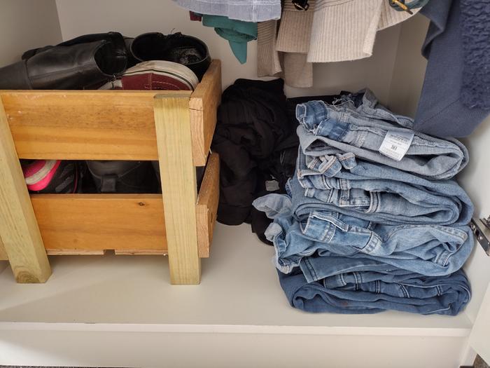 I don't have a chest of drawers or space to hang my trousers so I've folded them neatly according to colour. My tracksuit bottoms are tucked against the crate and black trousers