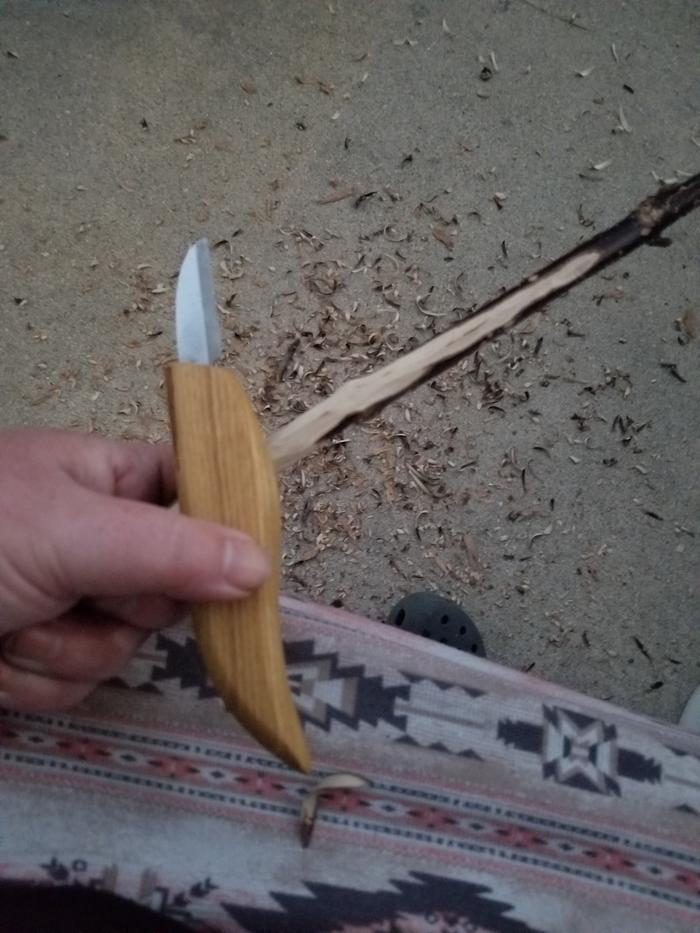 peeling the bark off the mop handle 
