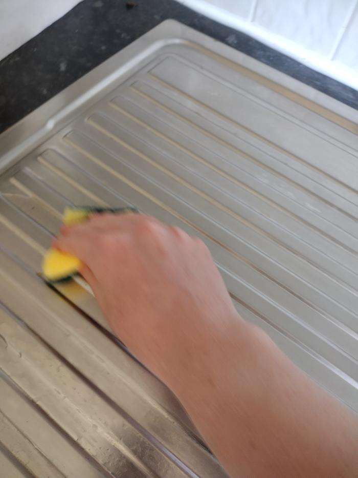 Using a sponge to wipe down the surfaces