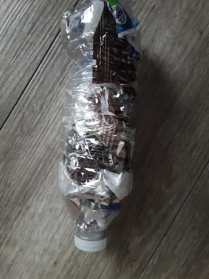 Plastic wrappers stuffed in a bottle