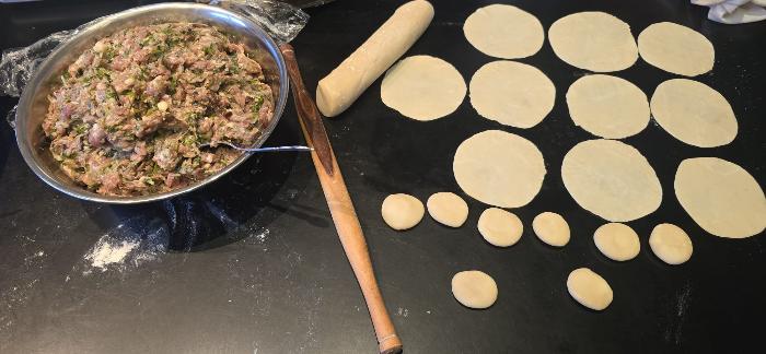 Pork filling and rolling the dumpling wrappers