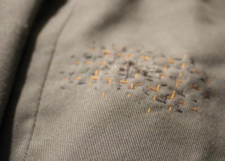 visible mending torn trousers