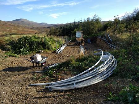 polytunnel frame under construction with mountains in background