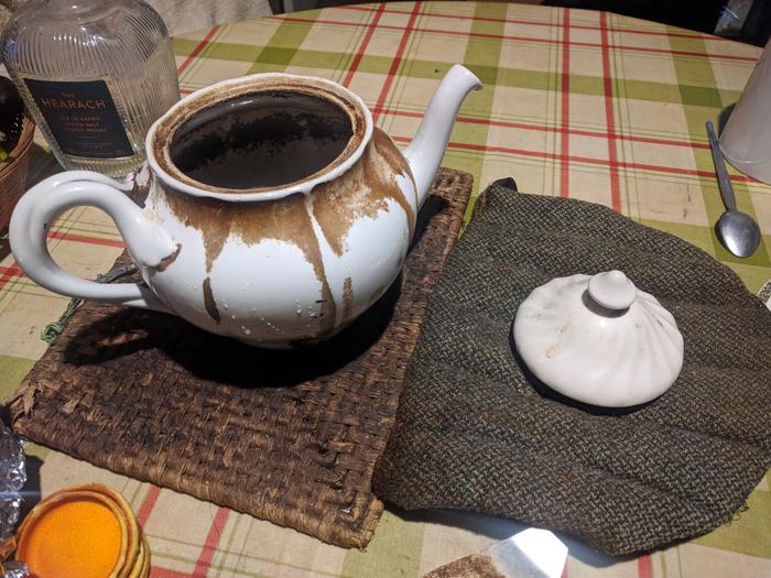 white teapot with tannin stanins