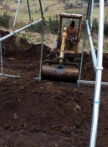 moving soil between poles in a mini digger