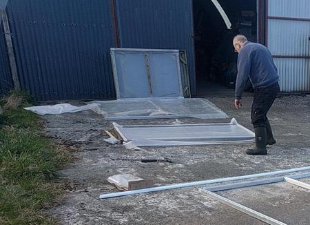 man in wellington boots on cement surface with polythene covered panels