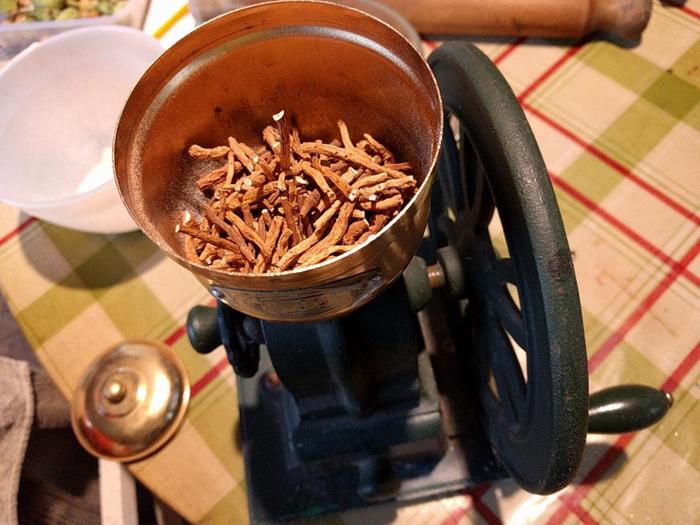 dried siverweed roots in old fashioned grinder