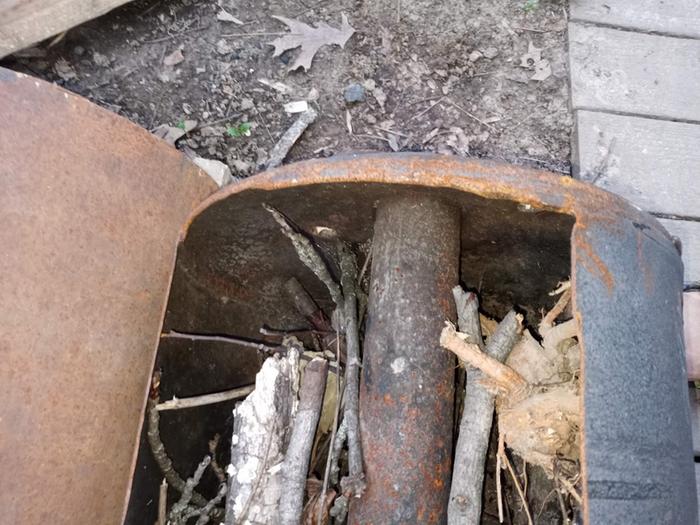 This is a biochar kiln made from a water heater tank, the central chimney clearly visible.