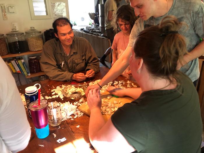 Garlic peeling party for a giant pot of pasta sauce