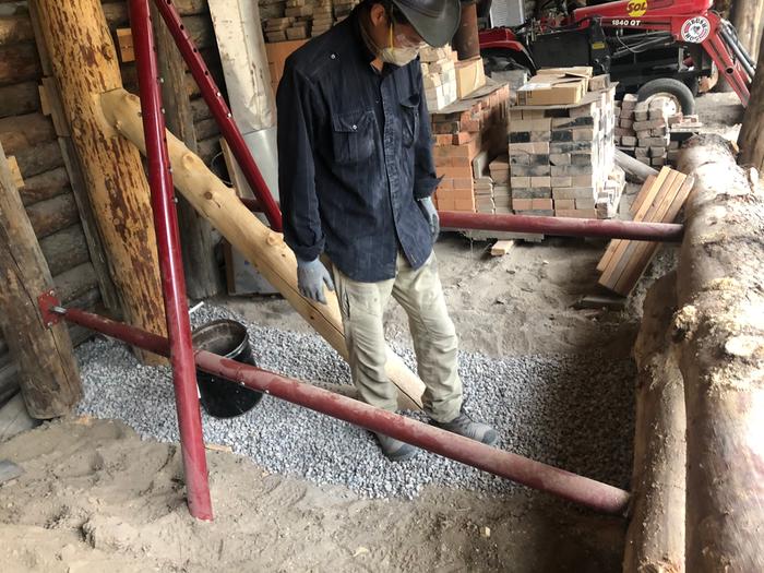 Tamping down the gravel as one of the last touches on the bermshed repair 