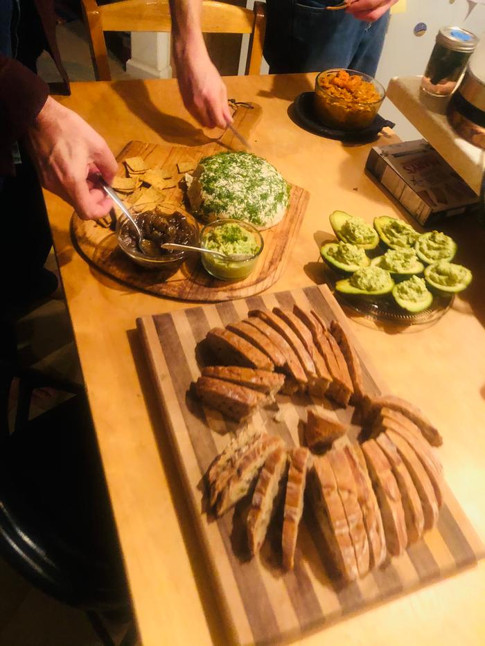 Thanksgiving hors d'oeuvres with a vegan cheese ball, onion jam, and avocado deviled “eggs” 