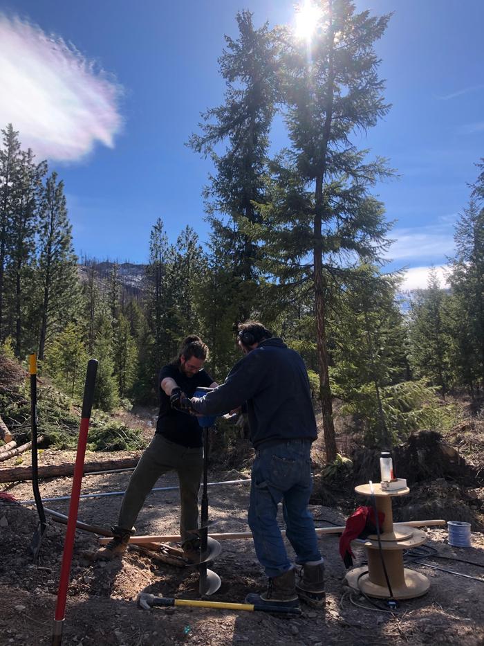 But still a few things yet to do before the setup is finished. Kyle and Jeff use the auger to make post holes for the solar panels. 