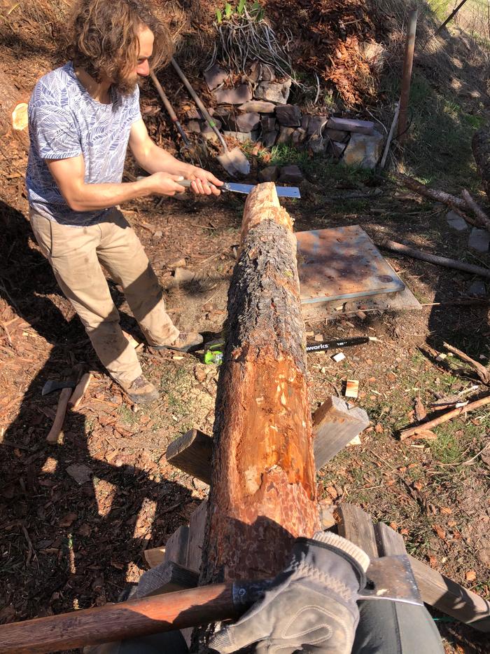 Stacking functions.... stabilizing the log while also peeling it as Ryan and grey work on the pegged ends 