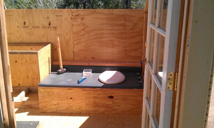 Crapper in. Ladies is to right but not installed at time of picture.