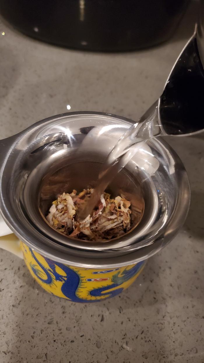 pouring boiling water over dried leaves