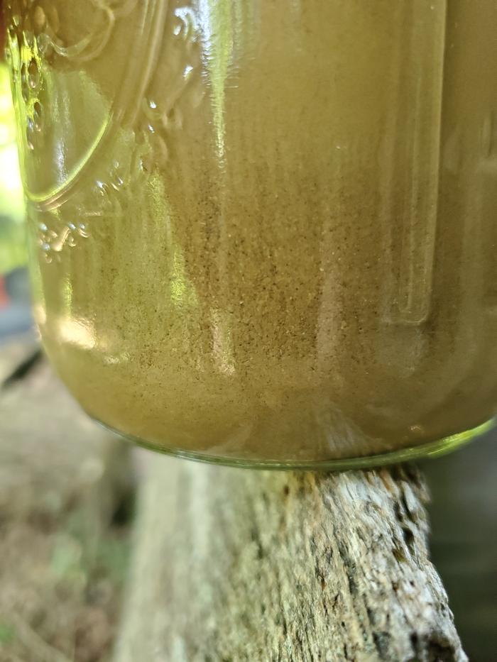 close up of mason jar soil test