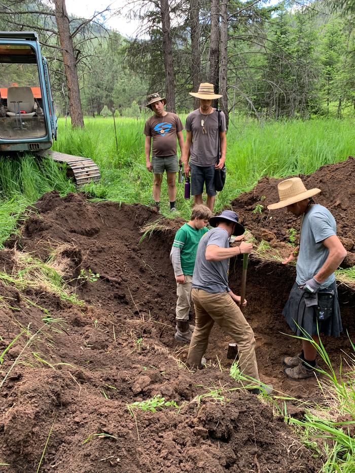 man-digging-for-pieces-of-clay-from-test-trench