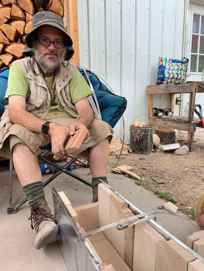 Uncle Mud sitting in front of a rocket core