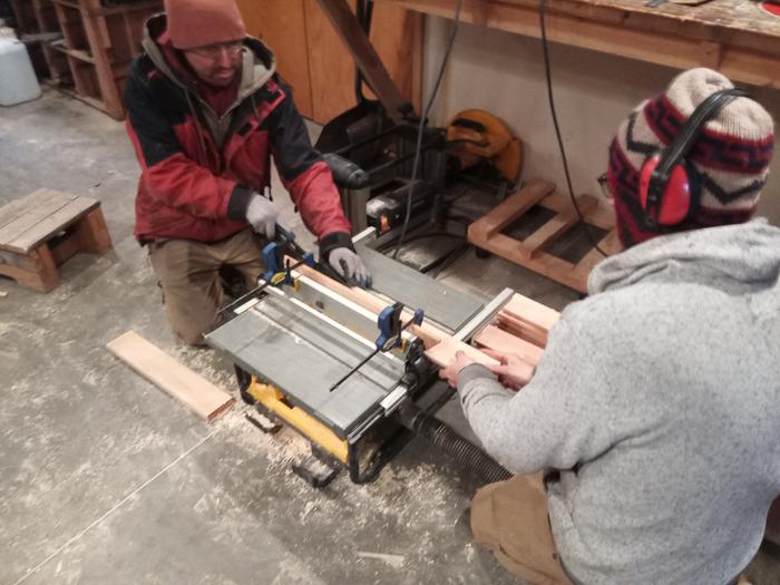 Fred and Daniel work the table saw