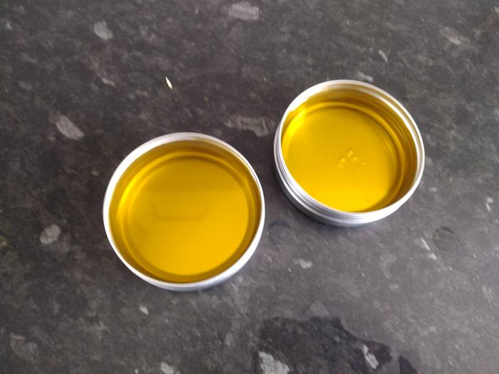 Oil and beeswax has been combined and has been put into containers