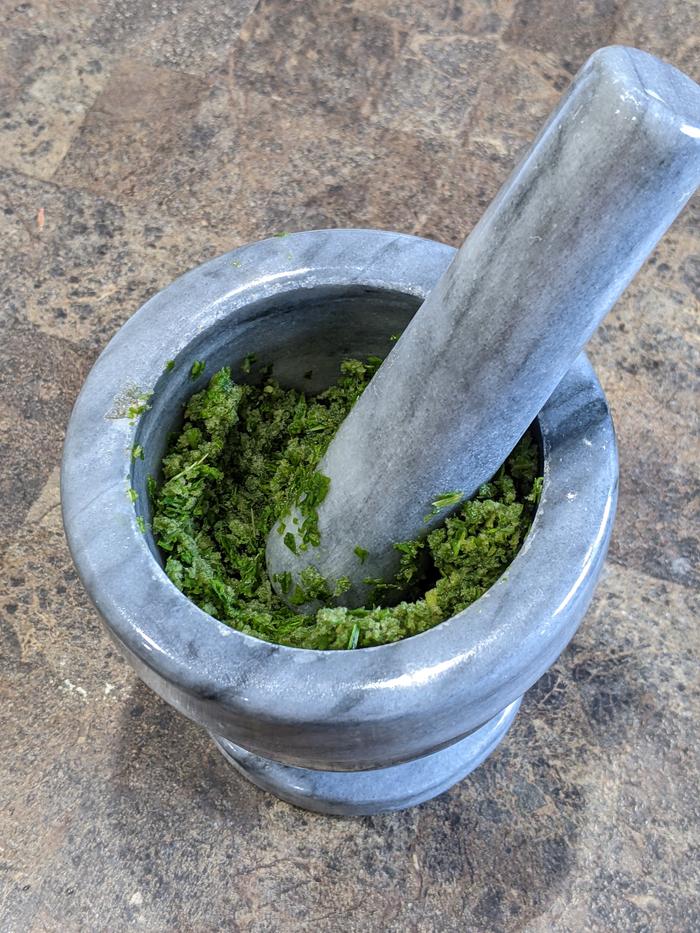 Making a mullein poultice with mortar and pestle 