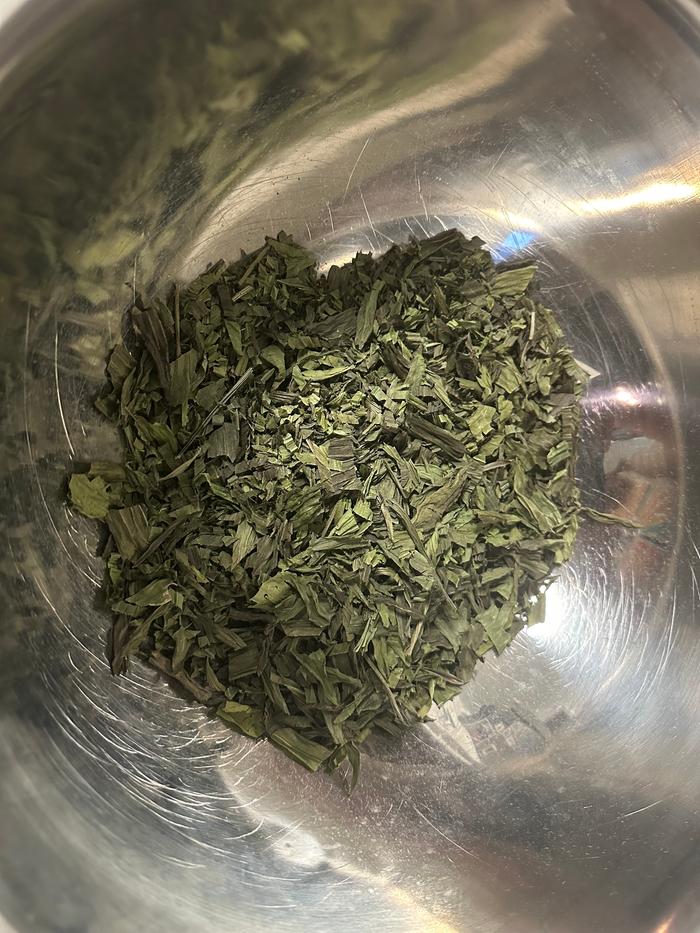 cutting up the dried plantain leaf into smaller pieces
