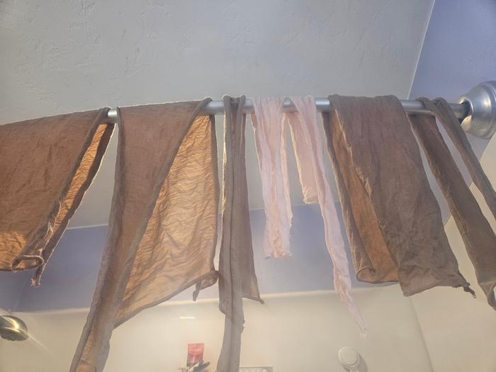 Fabric pieces hanging after dyeing 