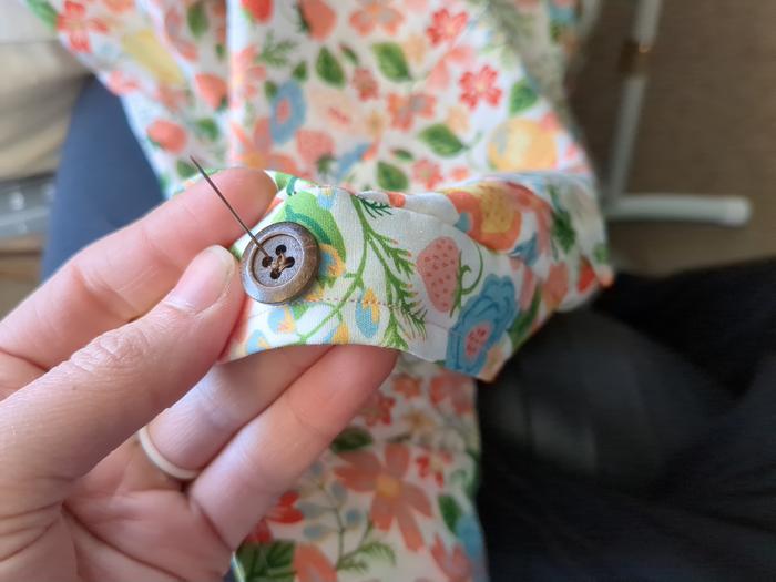 Sewing on the buttons.