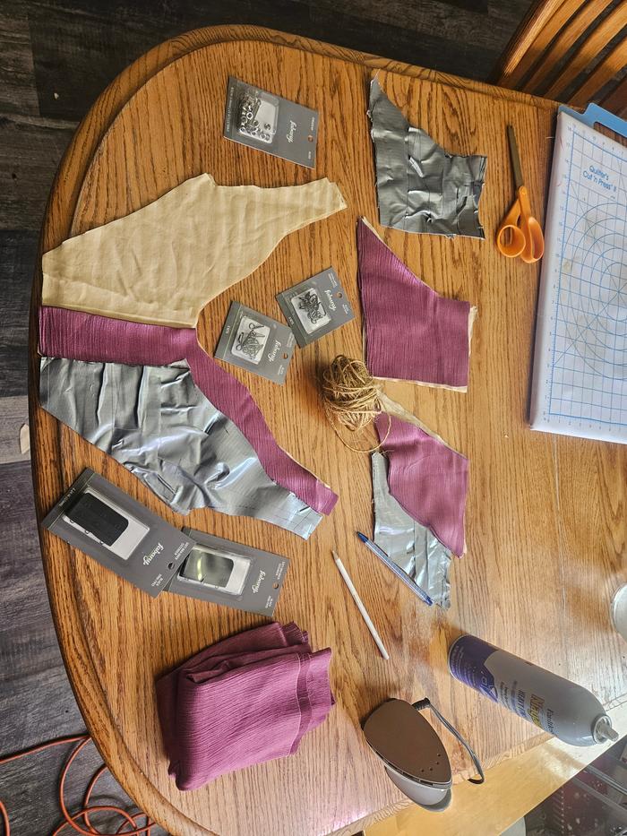 I then cut up the duct tape mock up into symmetrical pattern pieces and used them to shape the two layers of cotton and outer layer of silk