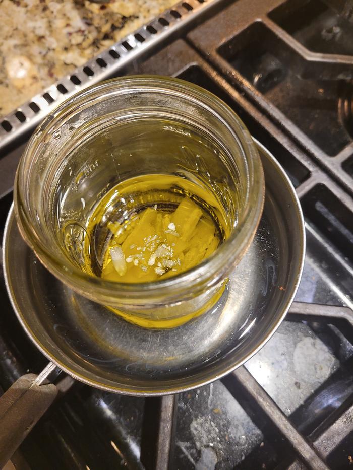 Combine oil and wax in double boiler.