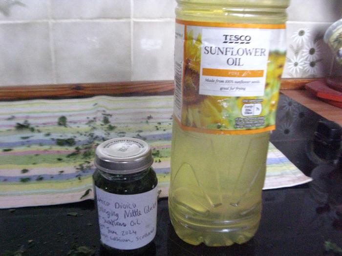 Labelled nettle infusion with oil ingredient.