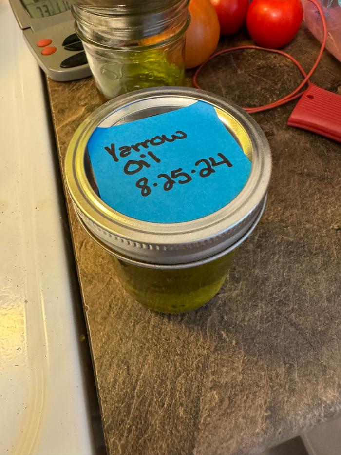 Labeled jar of yarrow oil