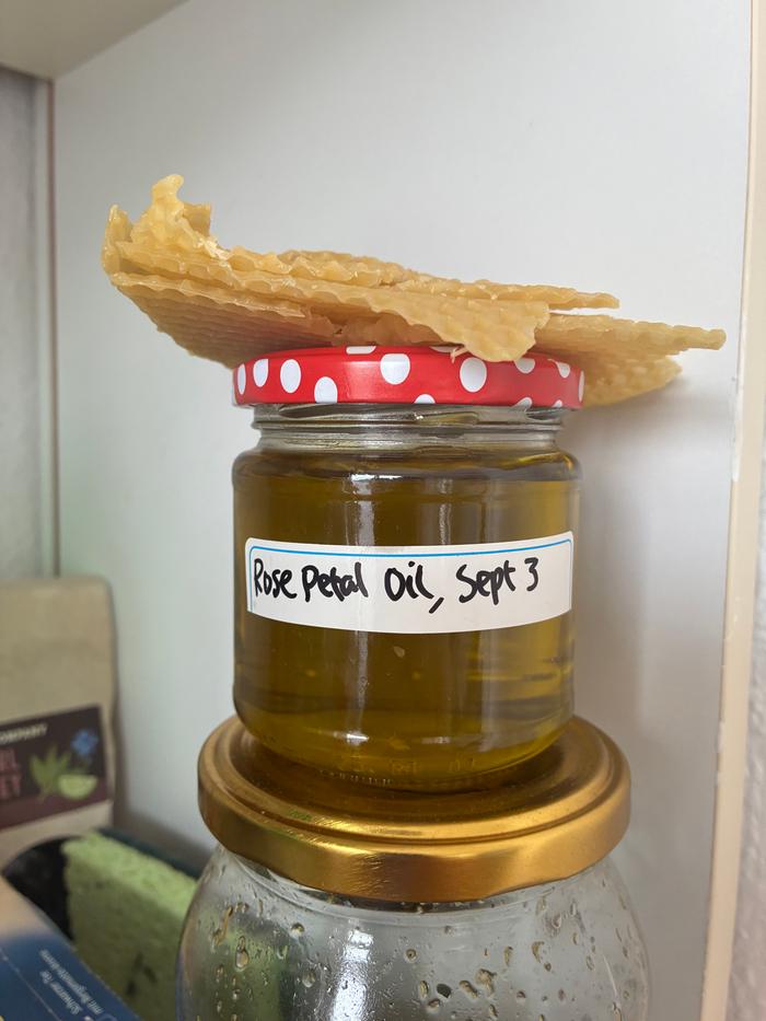 Organic extra-virgin olive oil rose petal extract with beeswax on top.