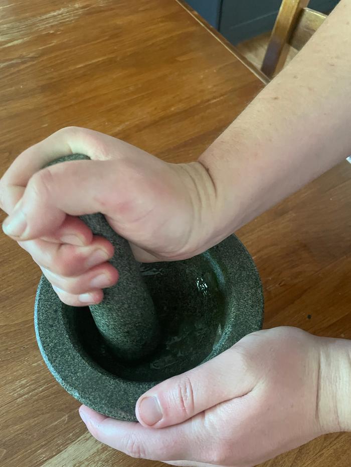 mashing aloe in a pestle