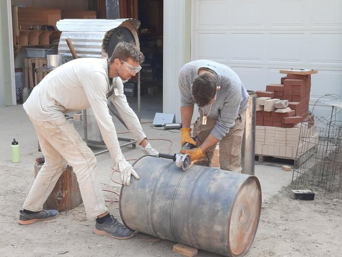 Joe and Isaac cutting the barrel for the Solarium RMH