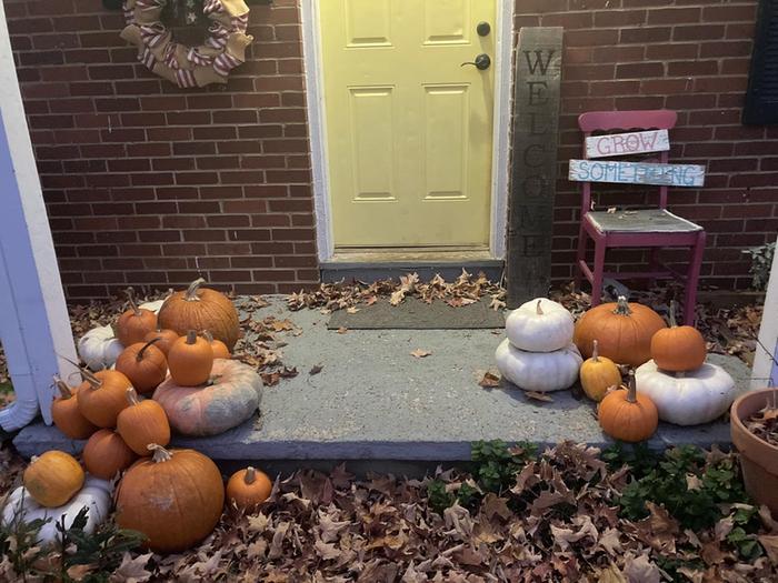 front porch decorated with a variety of winter squash