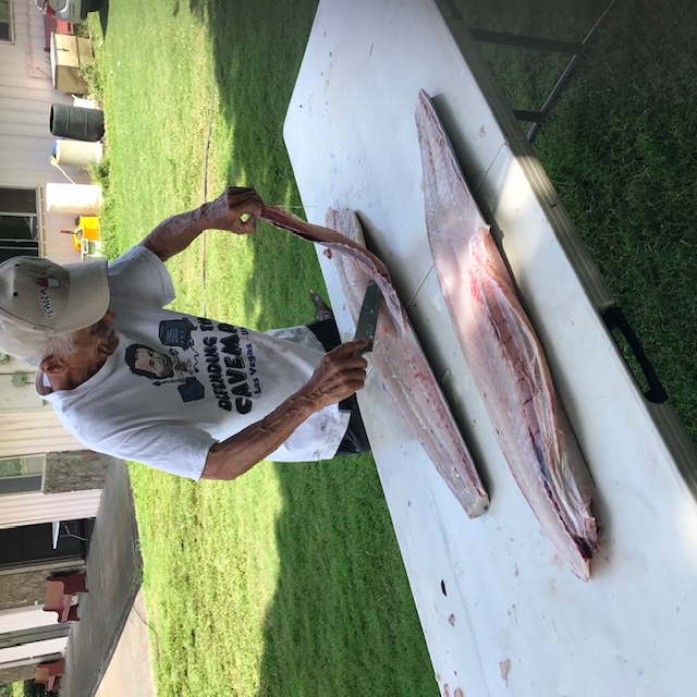 Cutting up the fish into individual pieces. 