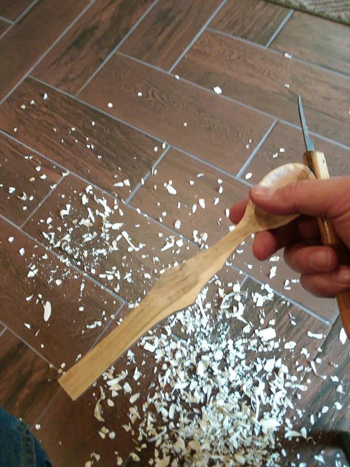 Not the best picture of it in use but some of of the curved shavings on the floor are from this knife as it made the bowl of the spoon