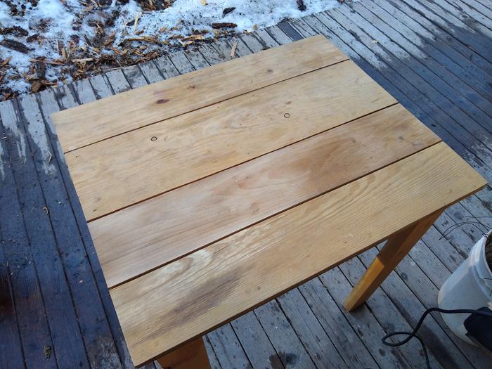 How does one clean an unfinished wood table