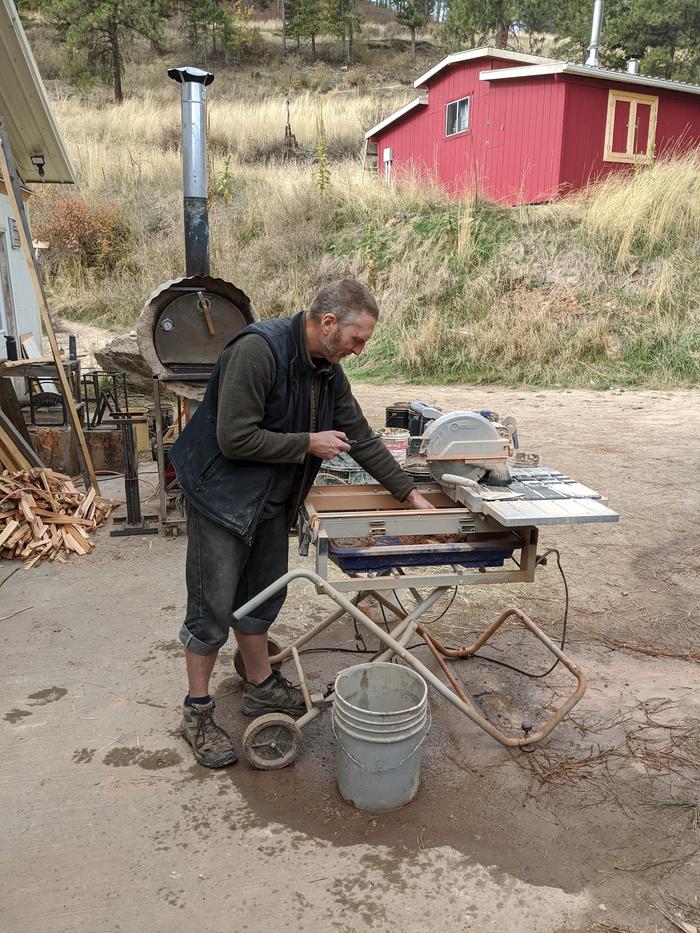 Yup, it's me taking a picture of Stephen, taking a picture of himself enthusiastically putty knifing the bricky $#!+ out of the tile saw water tray. 