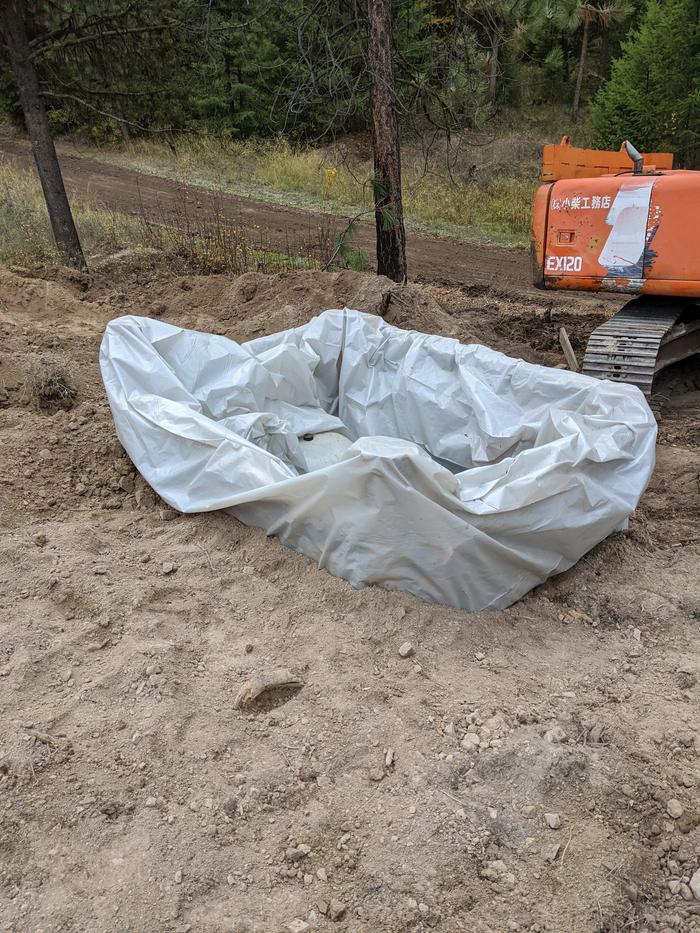 While I was grading the roads with the box blade the rest of the crew were doing the really important stuff. Filling in around the pumphouse became an asap priority with the temps dropping out the last night and winter's imminent arrival.