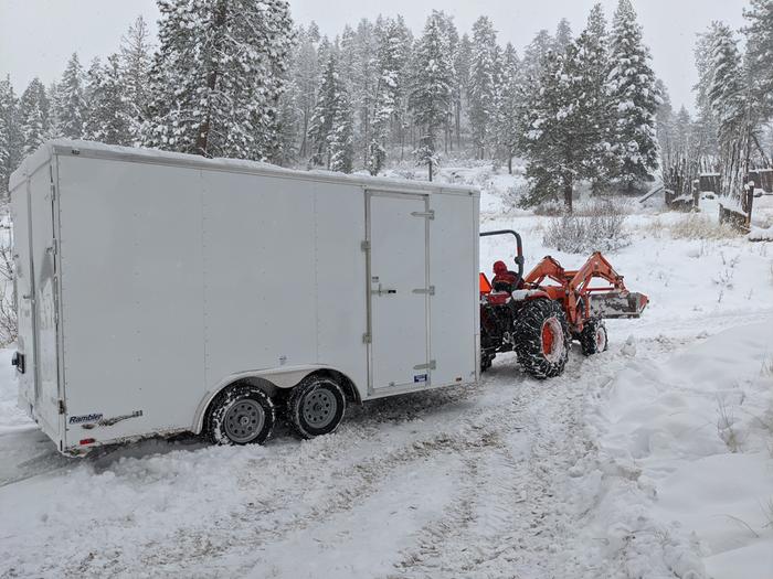 Real bad timing for our new trailer to arrive with the weather but Fred getting it to its location where it'll get fit with shelves. 