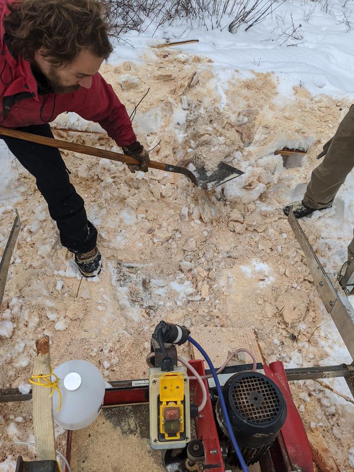 more saw milling in the afternoon - here Grey digs back a section of snow and Ice so the saw can be rotated to cut vertically. 