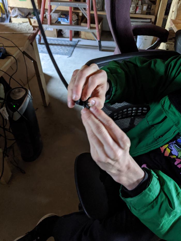 Wesley wiring in a plug for one of the several electrical projects that need to be done as.the paneling of the library nears completion. 