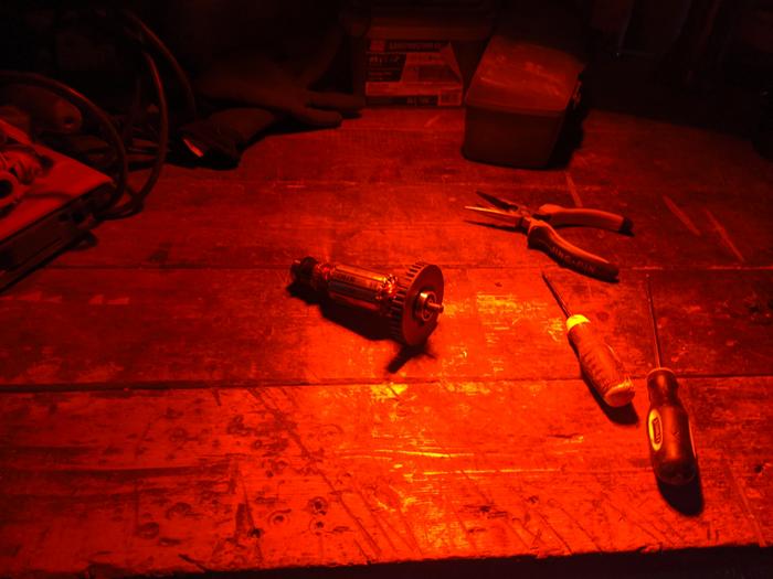 Here's a shot of the armature from our belt sander as we try to remove what's left of a shredded bearing - with spooky heat lamp lighting (cold in the AM)