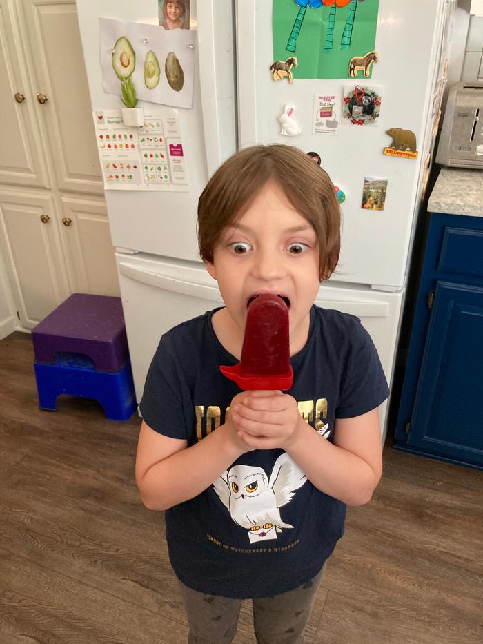 My daughter eating a popsicle that I made from foraged blackberries