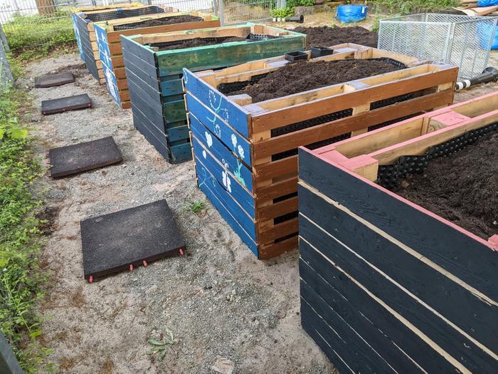 Six newly constructed large raised beds made from pallet wood. (Workdays 11 and 12) 