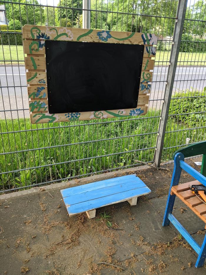 The original dual instructional blackboards fell during a wind storm. So I mounted one to a sturdy piece of a pallet with more screws and attaching screw-hooks.